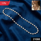 Close-up of gold-tone links on pearl beaded necklace