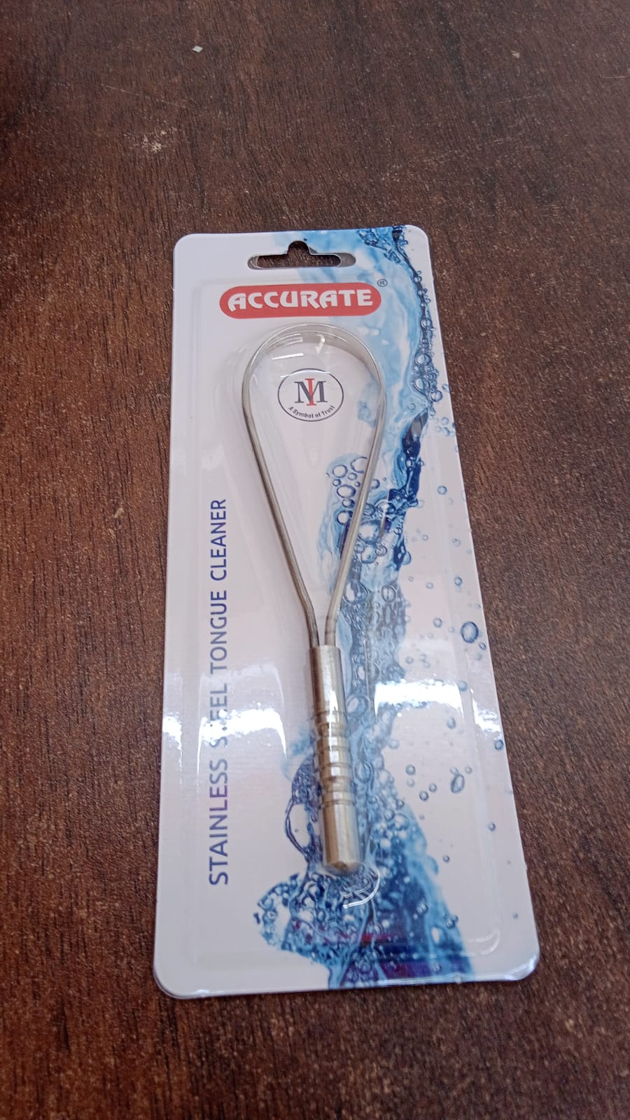 MintGuard Steel Tongue Cleaner positioned against a refreshing mint leaf background.