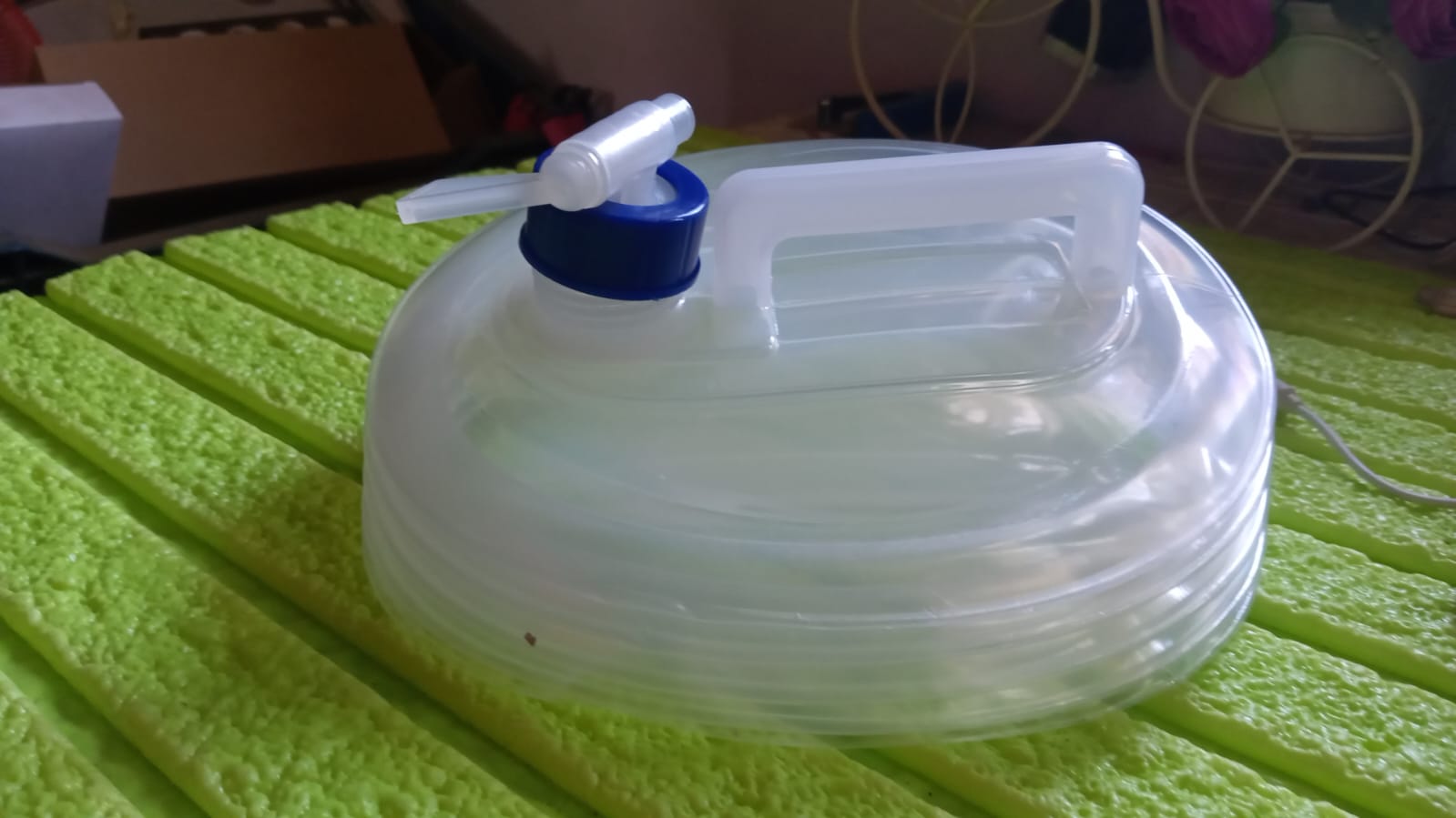 Compact and travel-friendly collapsible water carrier for easy storage.