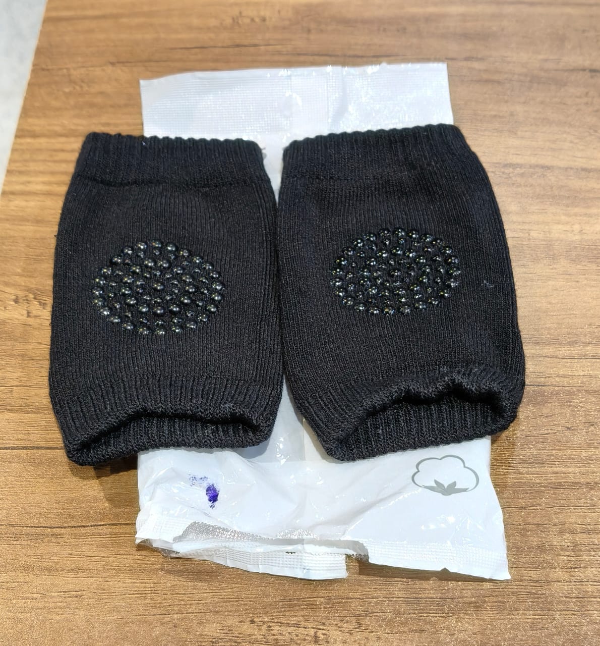 Black toddler wool knee guard shown in use providing knee protection