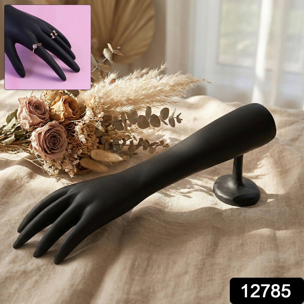 Jewelry display stand holding multiple rings and bracelets in black