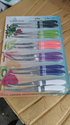 Versatile serrated knife from the 12-piece set cutting vegetables smoothly.