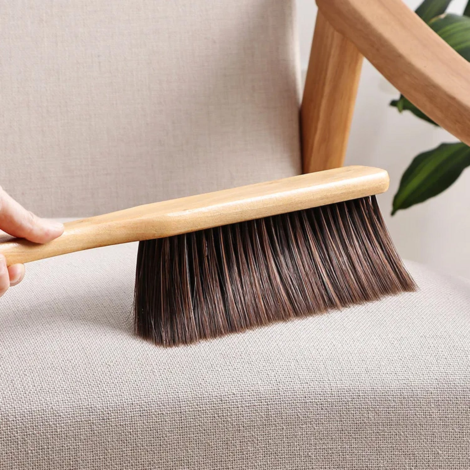 Side view of a soft bristle dust cleaning brush, highlighting its comfortable handle.