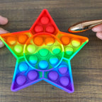 A vibrant yellow Star Fidget Toy displayed from a slight angle, highlighting its unique shape.