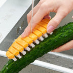 Carrot-shaped vegetable scrubbing brush on a clean white background.