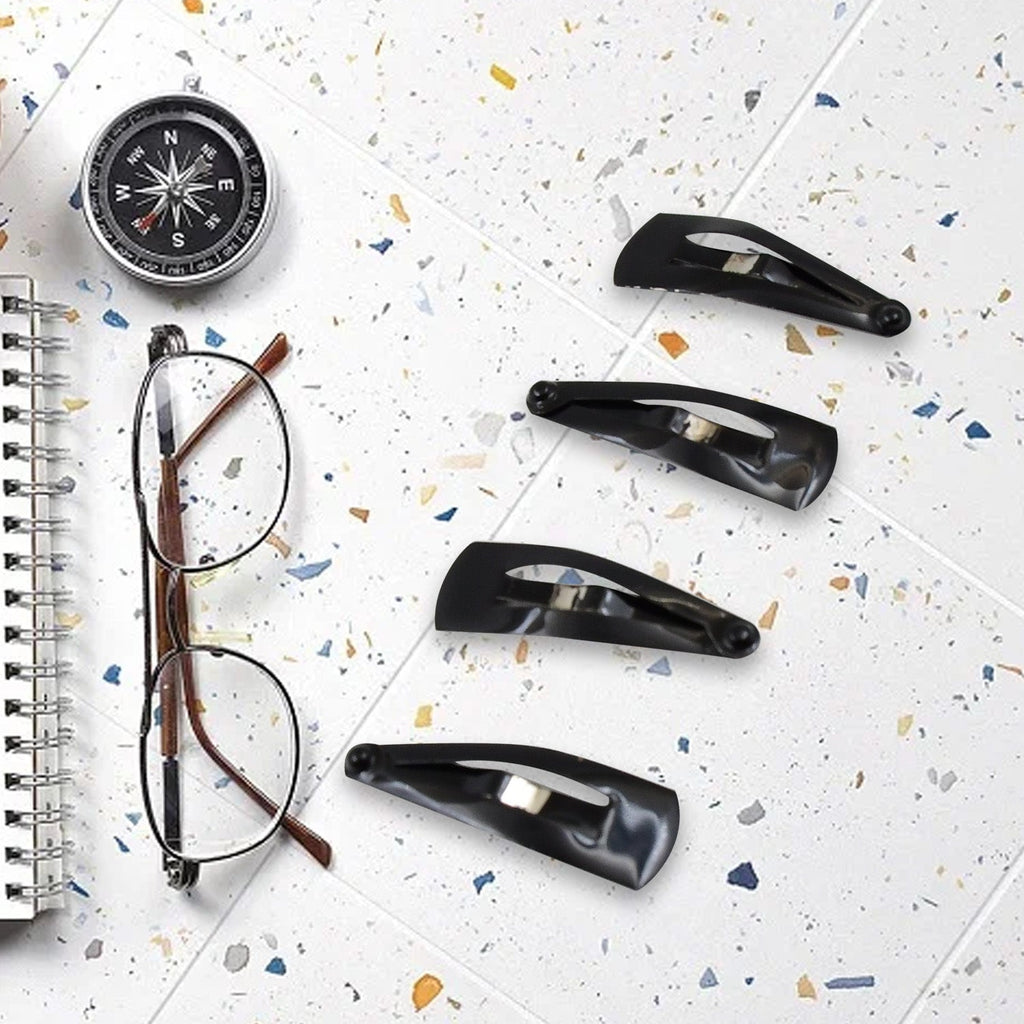 Matt black Metal Tic Tac Hair Clips on a neutral background, showcasing their sleek design.