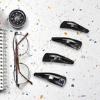 Matt black Metal Tic Tac Hair Clips on a neutral background, showcasing their sleek design.
