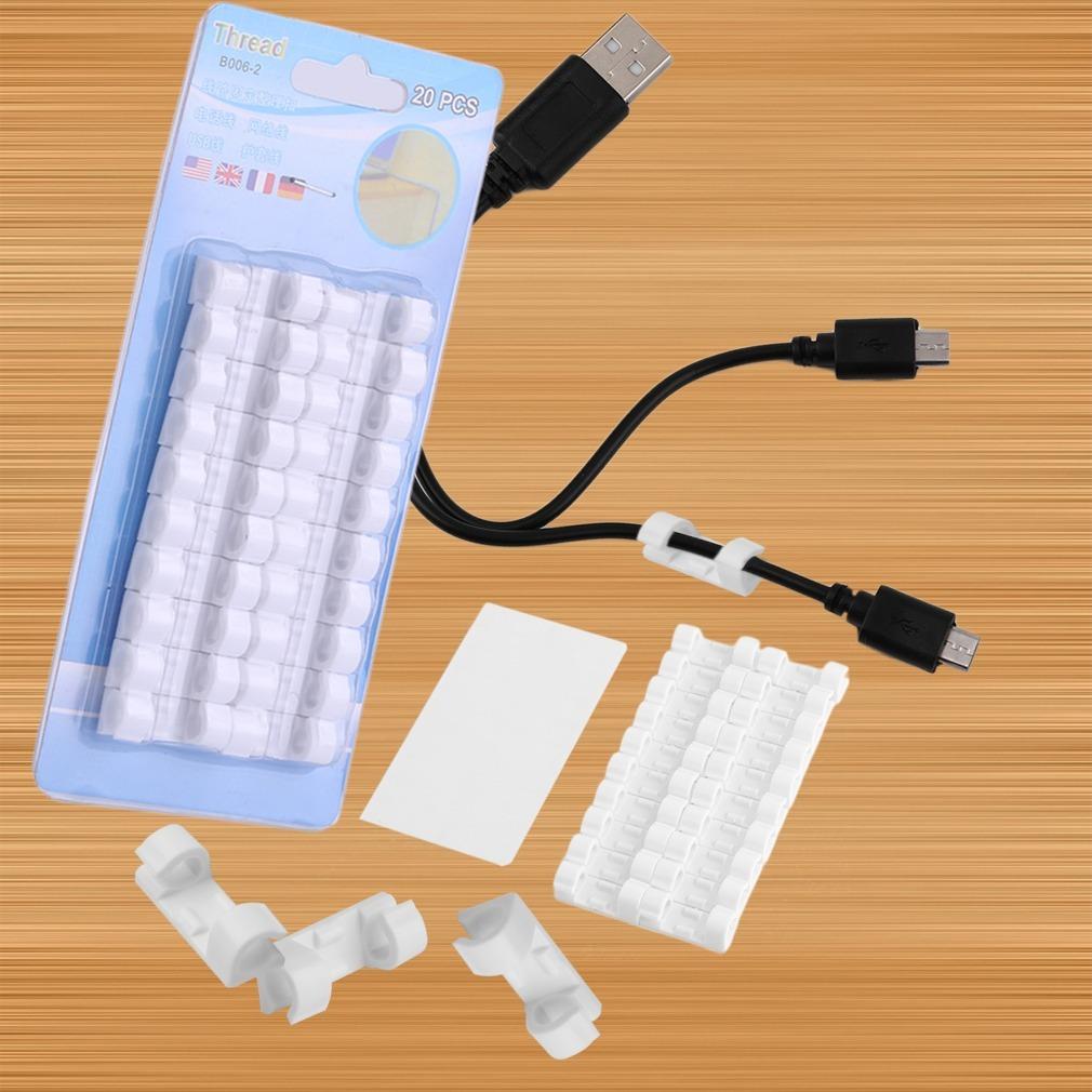 White self-adhesive cable clips arranged neatly on a clean surface.