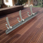 Wall mounted coat rack installed in an entryway with jackets and scarves hanging
