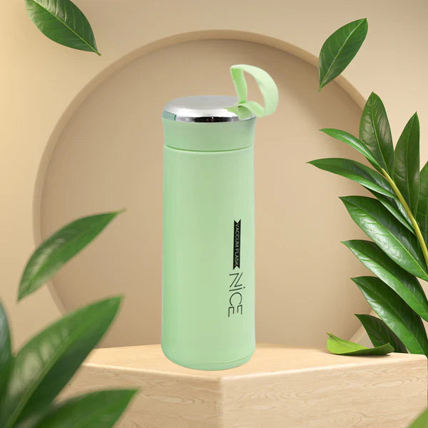 Close-up of glass water bottle 400ml leakproof bamboo lid in light green