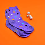 Two pairs of trendy designer socks for women, showcasing different fun prints.