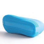 Detail of a silicone rain boot cover stretched over a shoe, emphasizing its snug fit and protection.