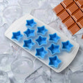 Silicone ice cube tray with star, heart, and strawberry shapes, filled with clear ice cubes.