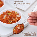 Dining spoons arranged neatly on a dark background