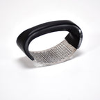 The ergonomic grip handles of the Quickslice garlic crusher, designed for comfortable use.