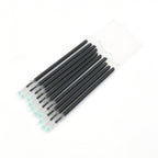 Multiple InkGlow black pen refills arranged neatly on a surface.