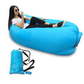 Trekola inflatable camping lounger set up in a serene outdoor campsite.