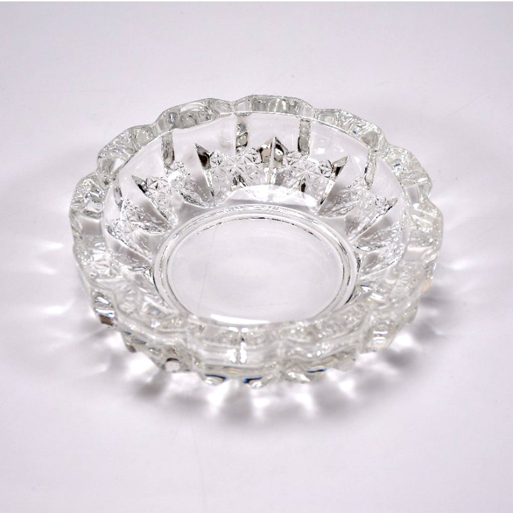 Stylish clear glass ashtray on a tabletop, enhancing home or office decor.