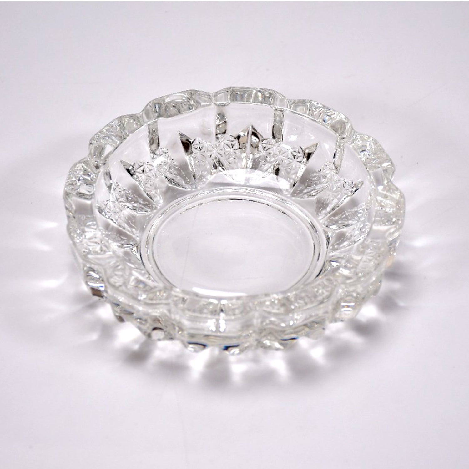 Stylish clear glass ashtray on a tabletop, enhancing home or office decor.