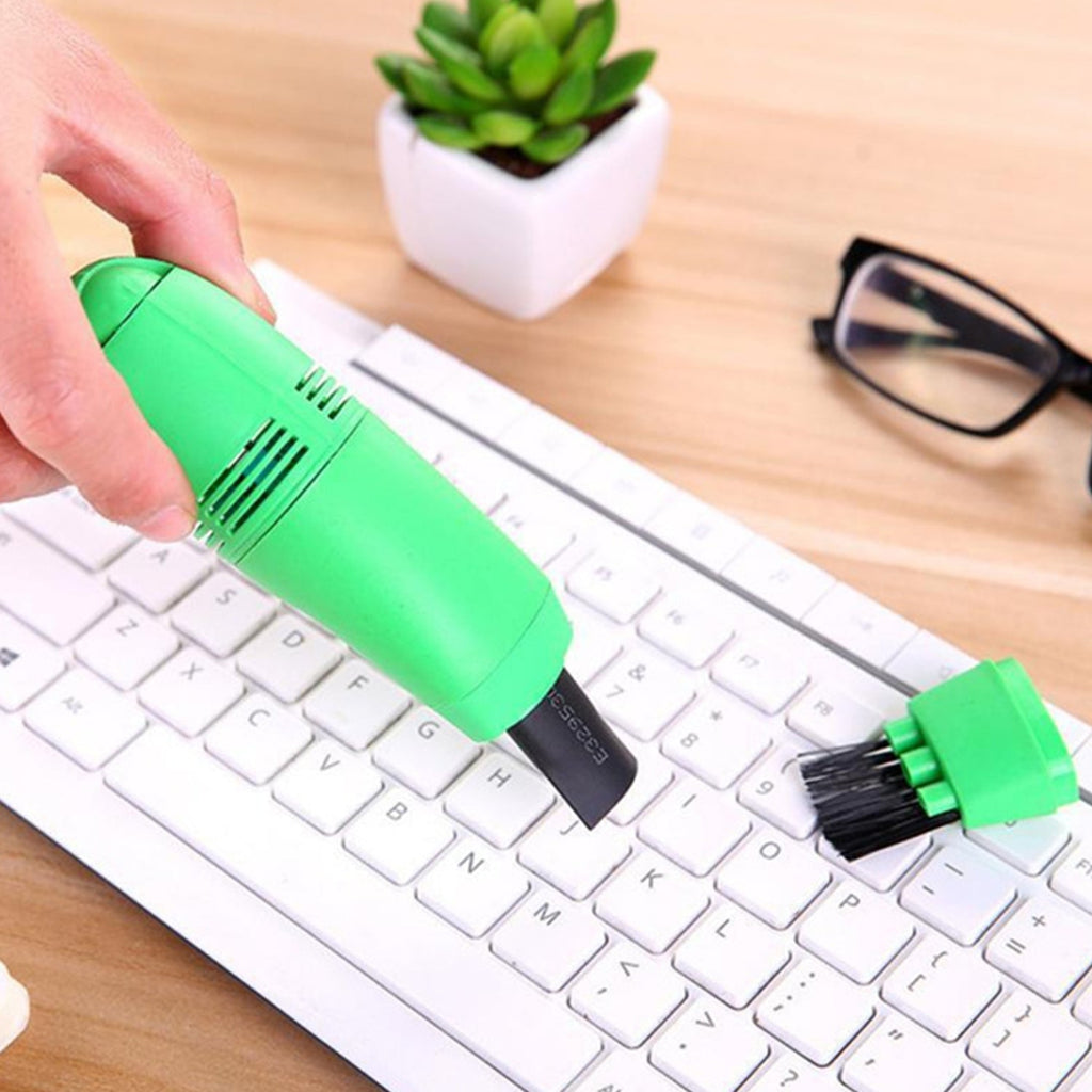 USB mini vacuum cleaner designed for dual use in cars and computer workspaces.