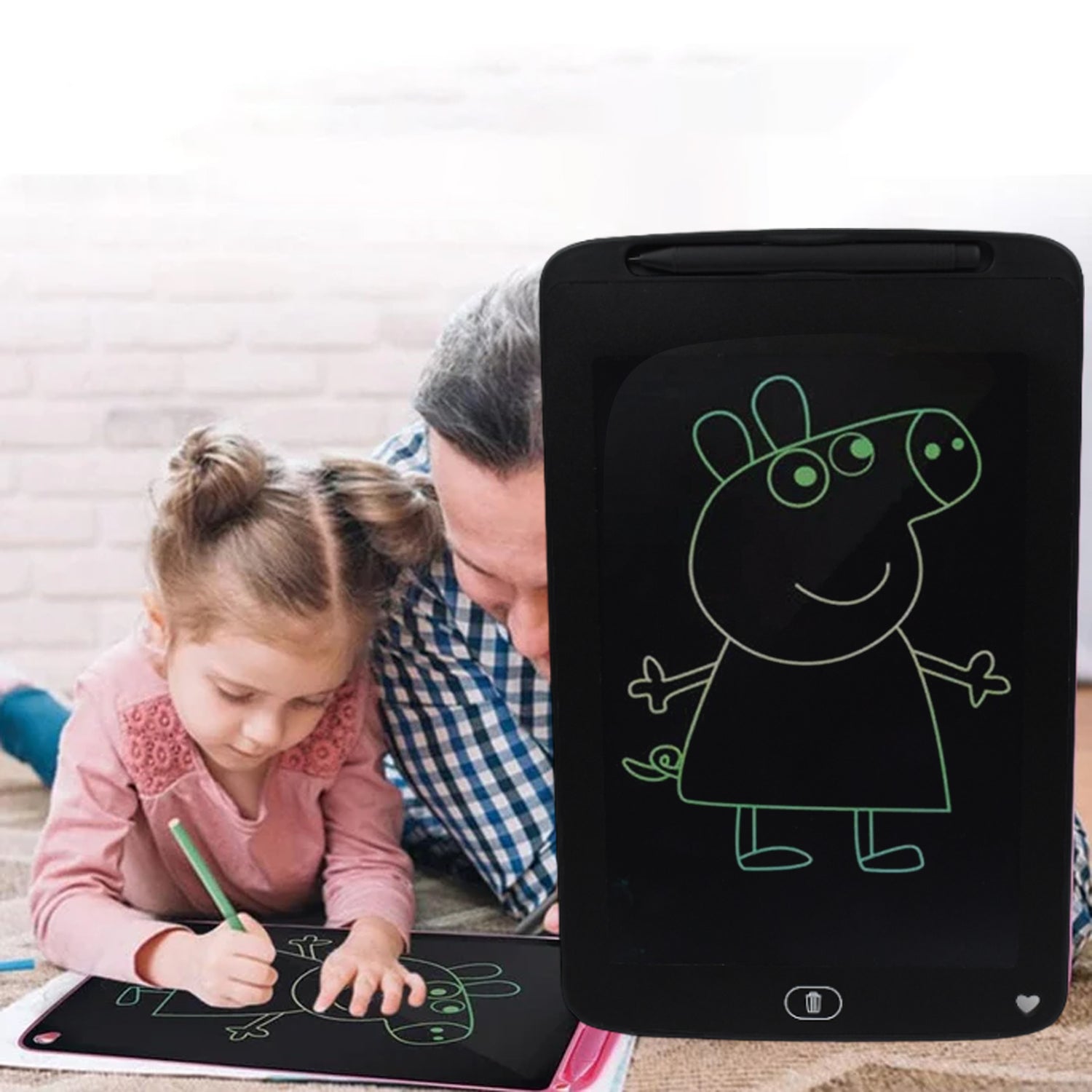 A child happily drawing on a 10-inch LCD writing board with its stylus.