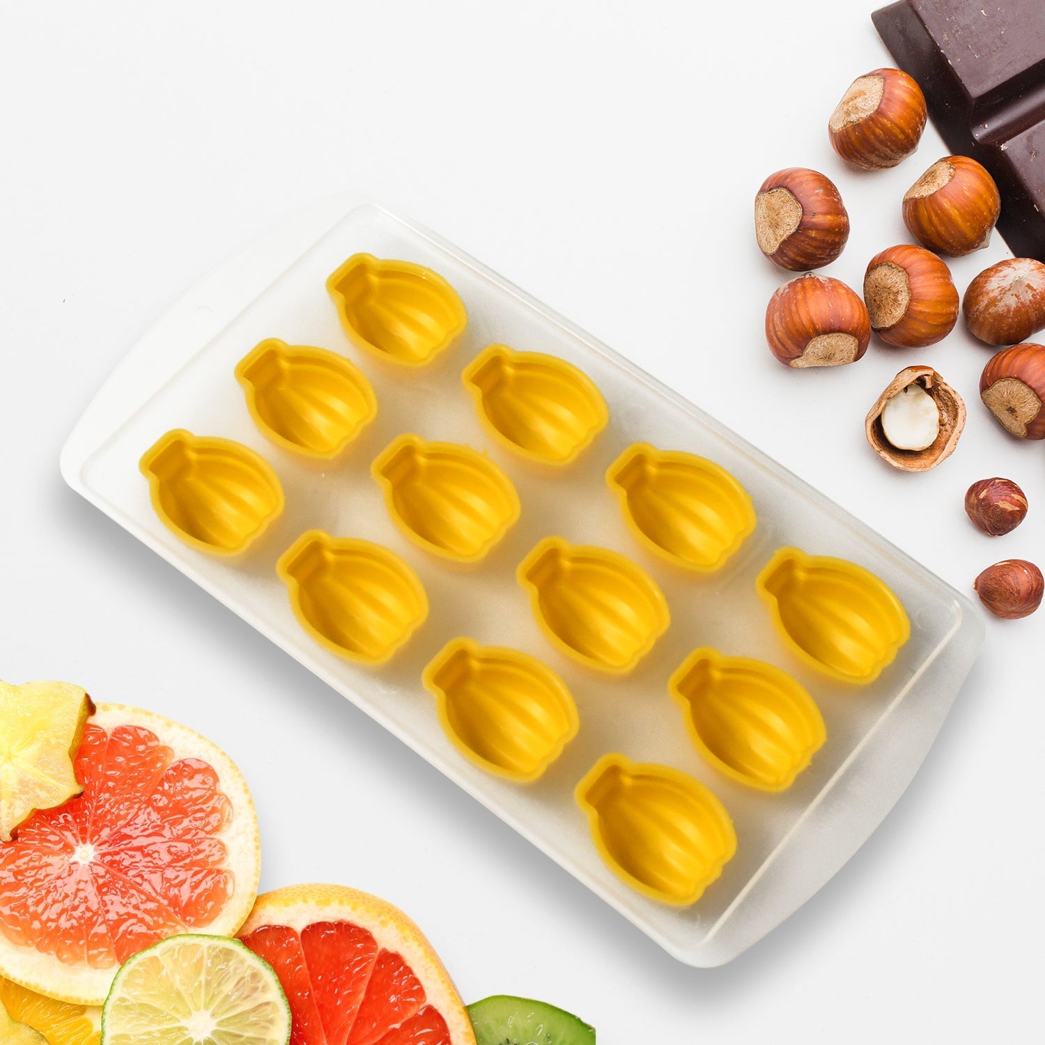 Colorful fruit-shaped ice cubes, perfectly formed from the silicone freezer mold, in a close-up shot.