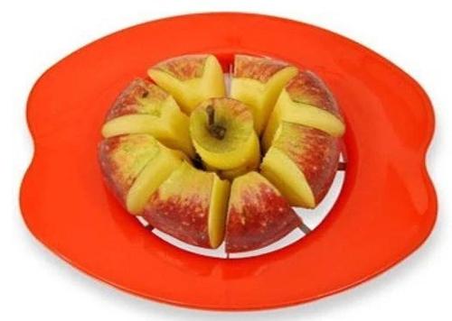 An apple being perfectly sliced into 8 pieces by the Quickslice apple corer.