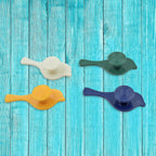 An array of self-adhesive bird hooks in use, holding various household items.