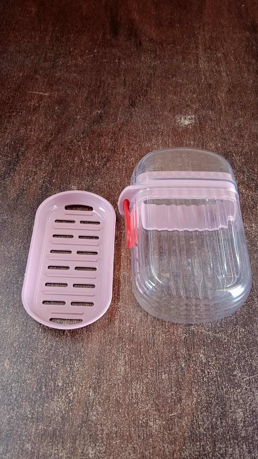 Compact pink plastic soap dish ideal for travel and home bathroom use