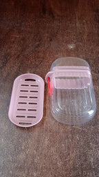 Compact pink plastic soap dish ideal for travel and home bathroom use