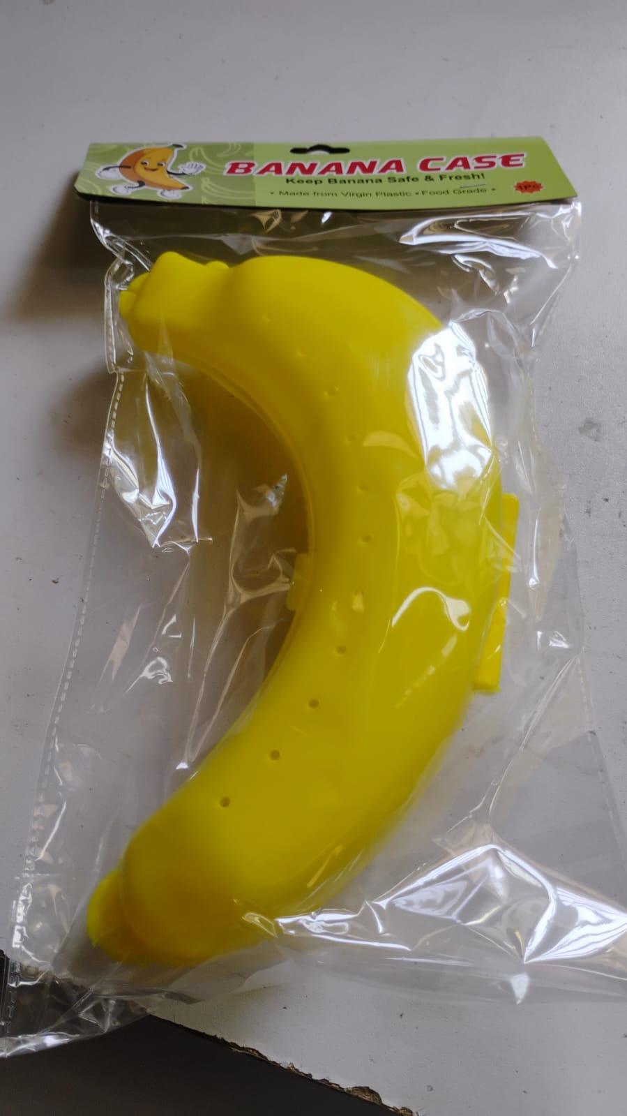 Vertical shot of the vibrant yellow banana case, showcasing its slim profile.