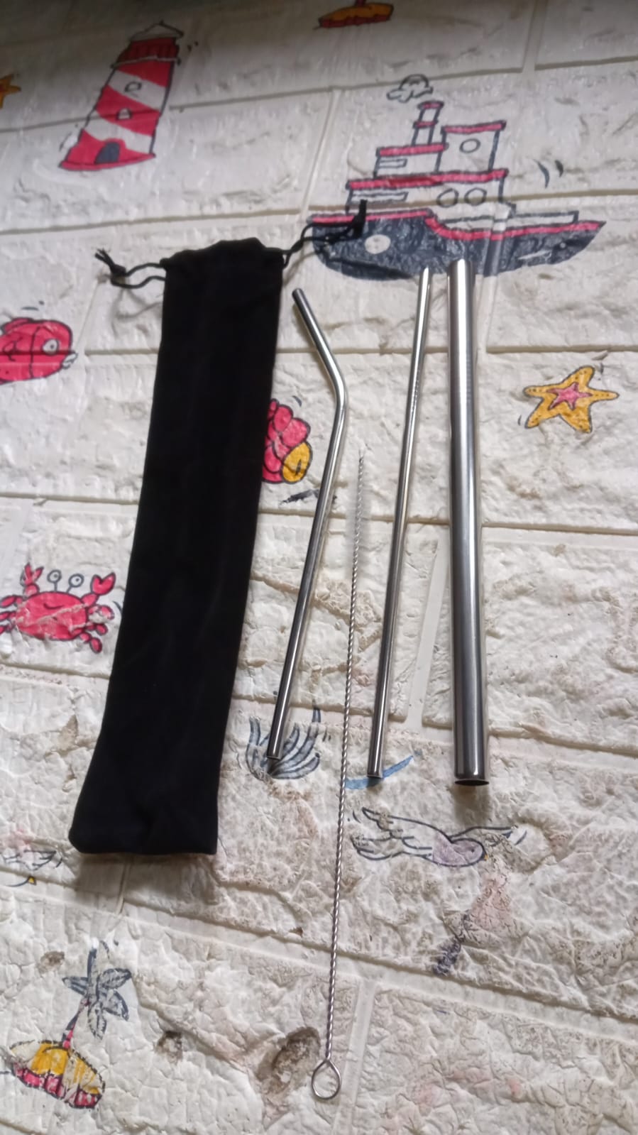 Eco-friendly packaging for the Happy Bathers' reusable stainless steel straw set.
