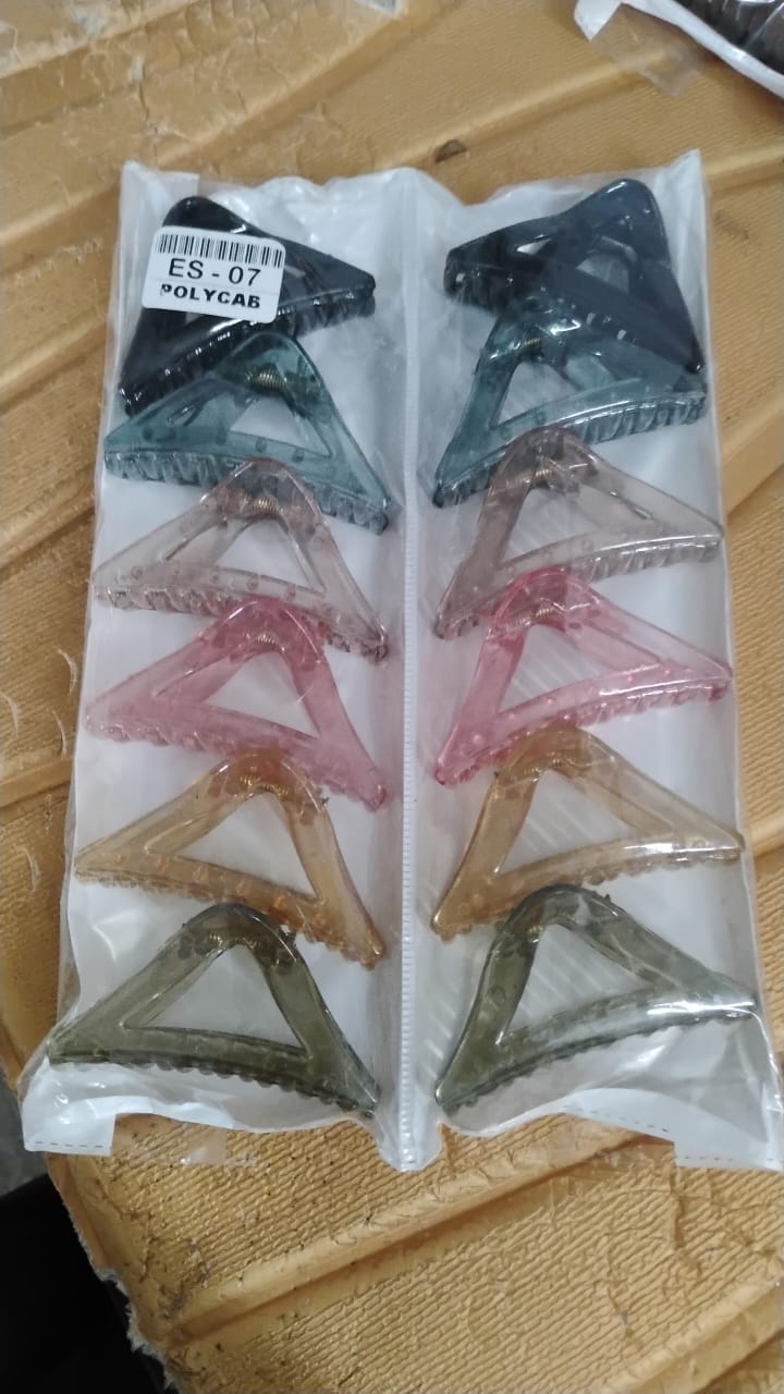 Colorful triangle shaped plastic hair claw clip styled in hair for a chic look