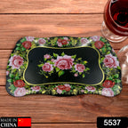 Top-down view of a rectangular floral stainless steel serving tray, highlighting its design.