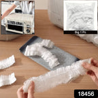 A large dining table covered with a clear disposable furniture protector.