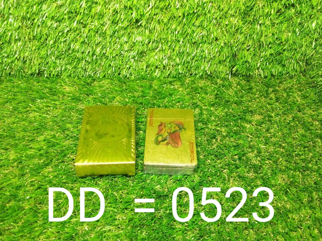 A single gold-plated playing card held, emphasizing its flexibility and durability.