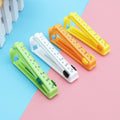 Set of four vibrant food sealing clips with date dials, perfect for keeping food fresh in an Indian kitchen.