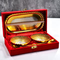 Elegant gold and silver plated brass serving set with two bowls, two spoons, and a red velvet gift box.