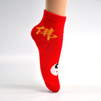 A pair of comfortable designer socks featuring a festive theme, ideal for gifting.
