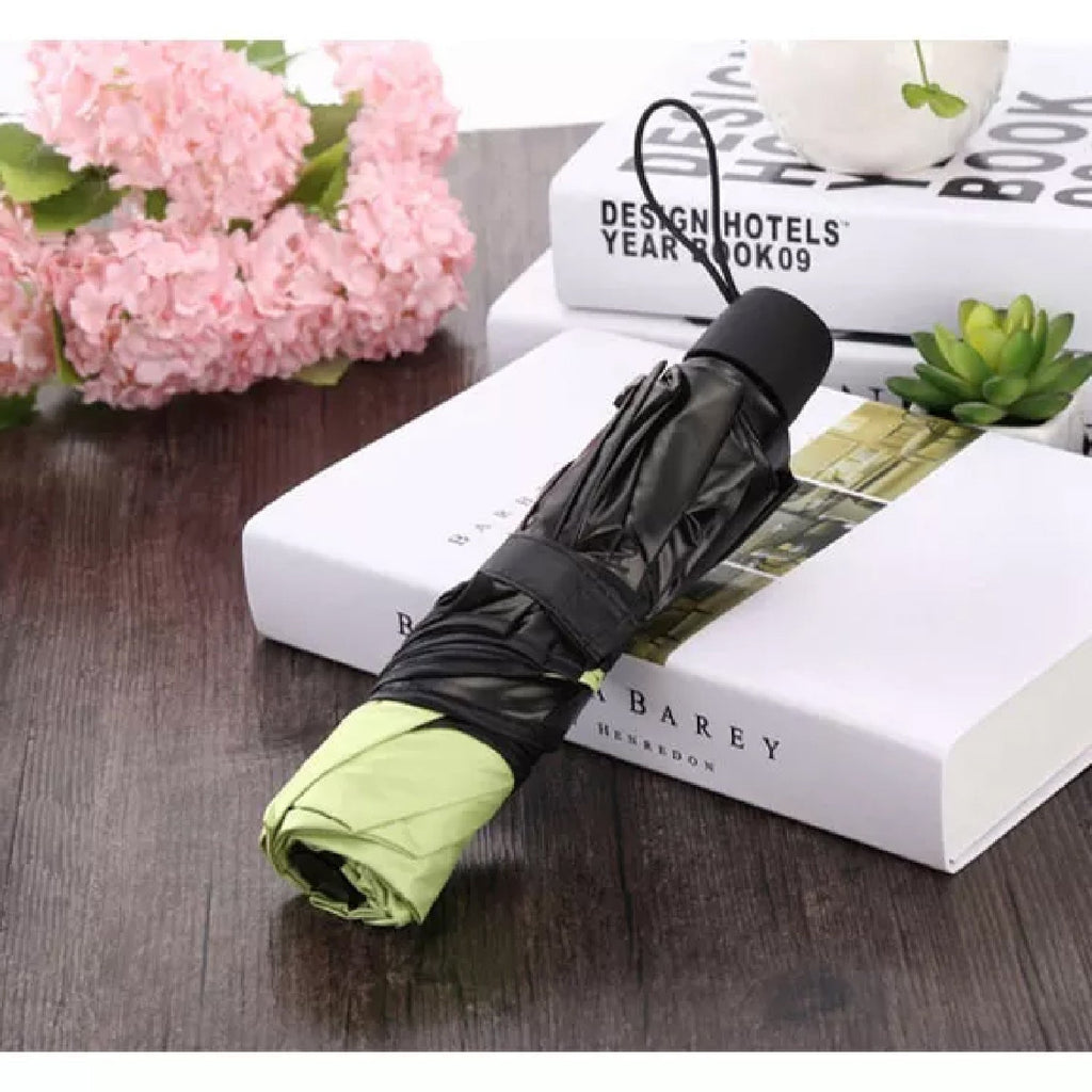 A compact Magic Umbrella folded neatly, highlighting its portable travel size.