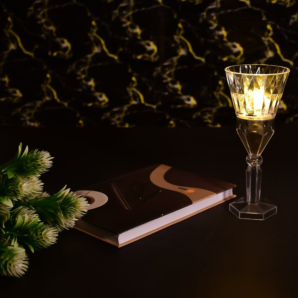 A transparent table lamp with an intricate crystal-like design.