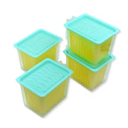 Transparent food storage containers with handles, showcasing fresh fruits and vegetables.