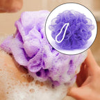 Various colored bath loofah sponges with hanging ribbons.