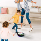 A child happily playing with the glowing Hover LED Ball indoors, showcasing its vibrant lights.