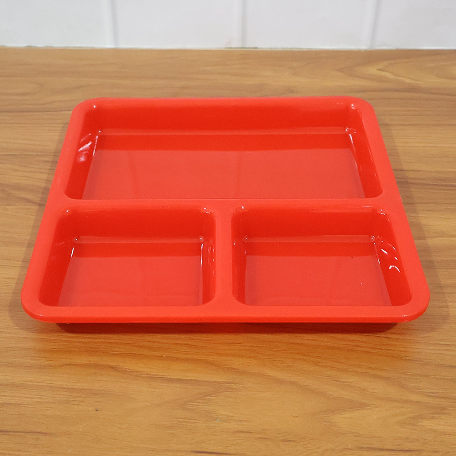 Ergonomic design of the plastic 3-compartment meal serving tray.