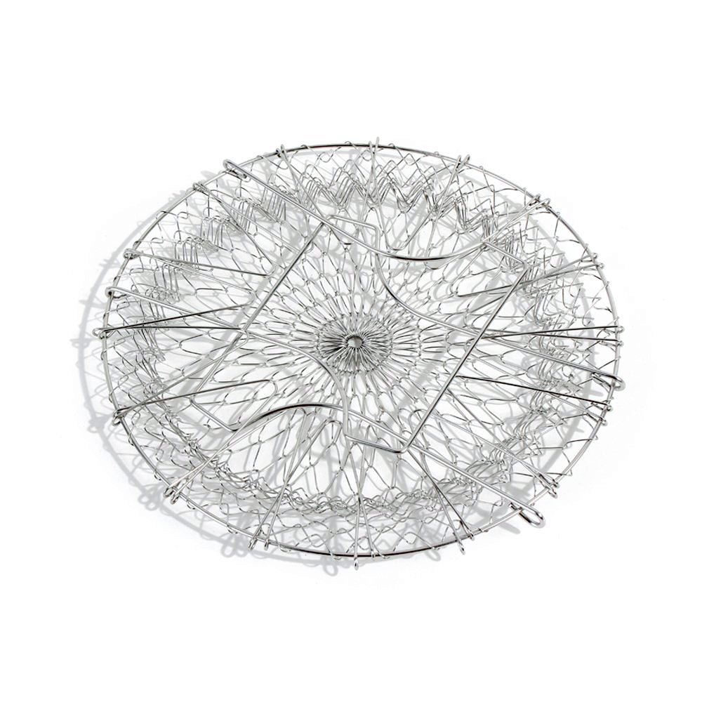 The durable stainless steel chef basket straining boiled vegetables for a healthy meal.