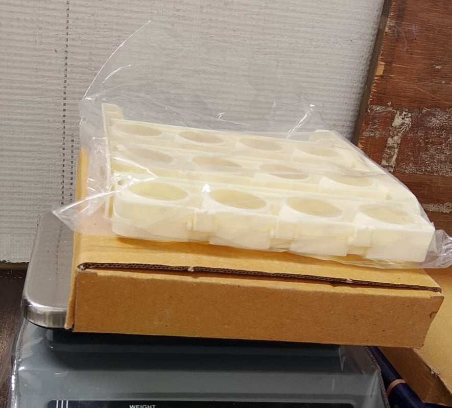 Foldable plastic egg tray neatly packed, ready for convenient storage or transport.