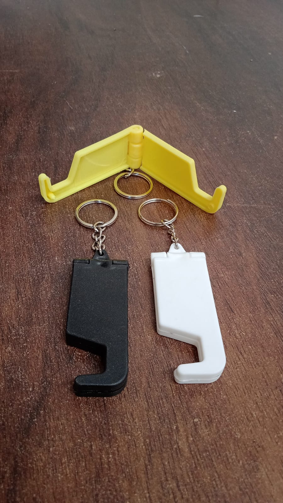 Multiple multicolor plastic keychain phone holders arranged together.