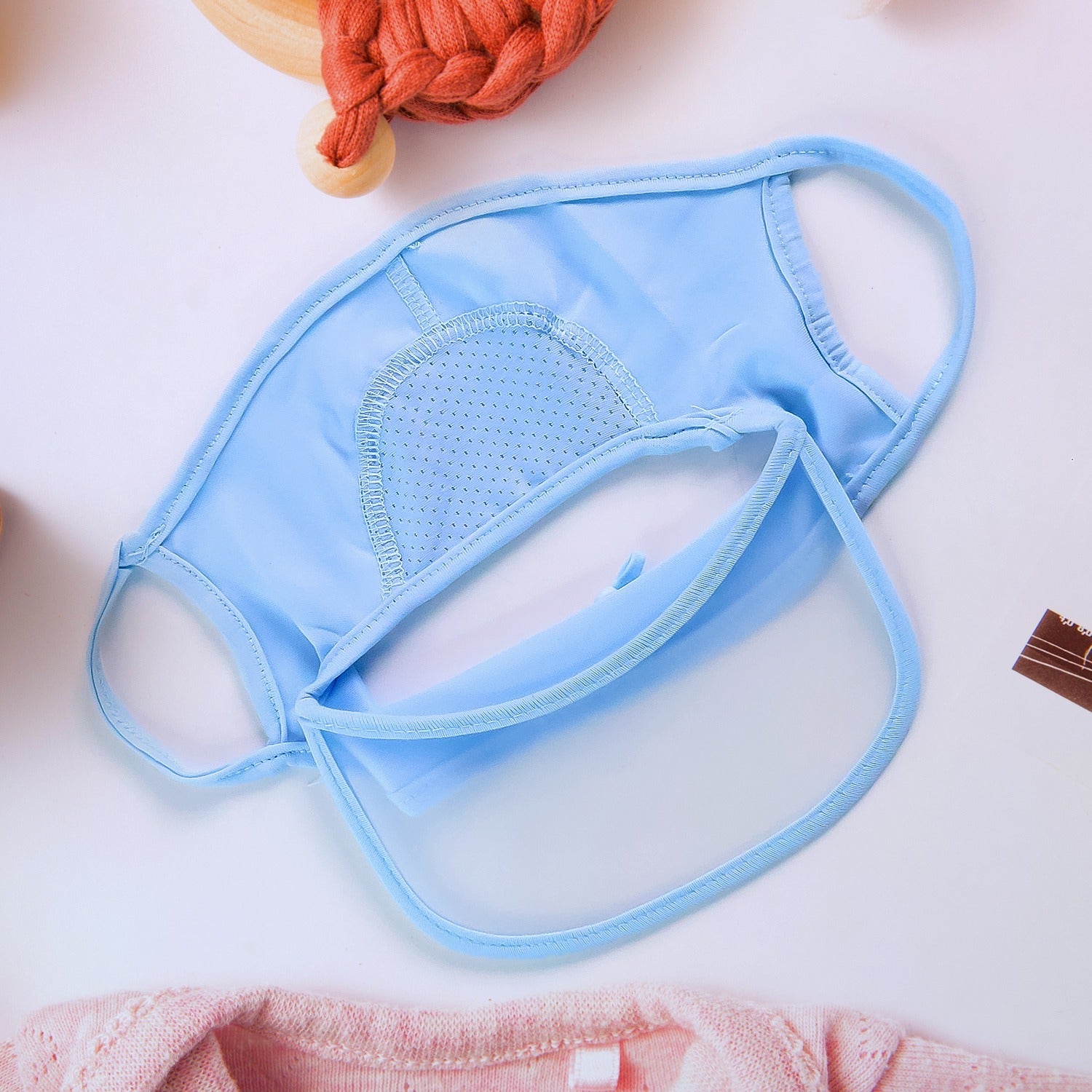 Various pastel-colored UV protection caps displayed, showing options for women.