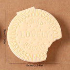 A child's hand holding the fun biscuit notebook, perfect for early learning and creative writing.